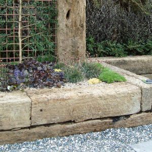 Reclaimed traditional railway sleeper used for garden retaining wall in Tauranga